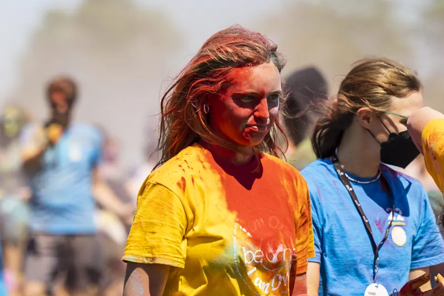 Participant covered in colored powder at an outdoor event