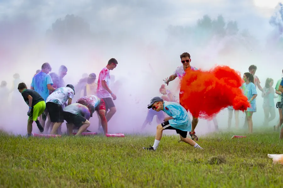 Colored smoke and participants during an outdoor color run