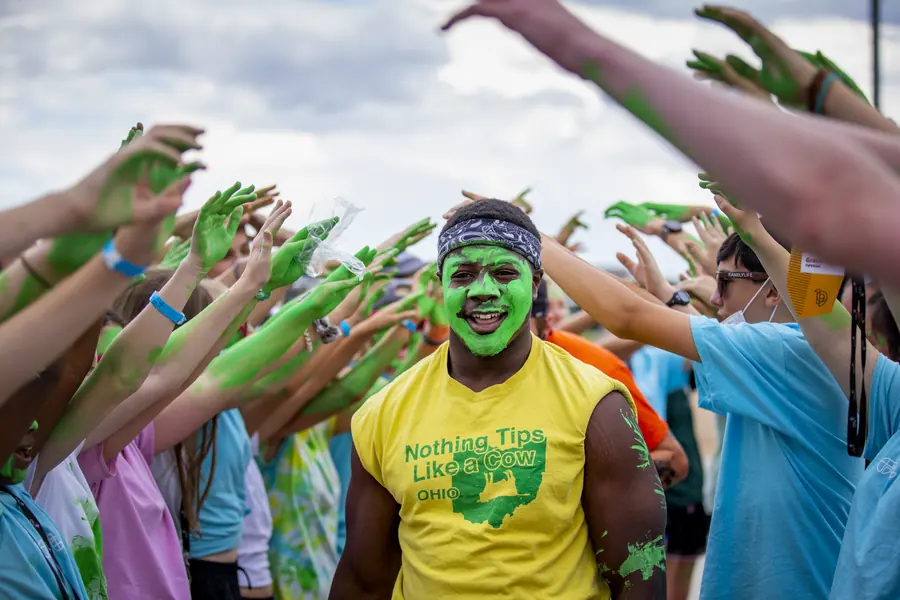 Participant running through a tunnel of raised hands