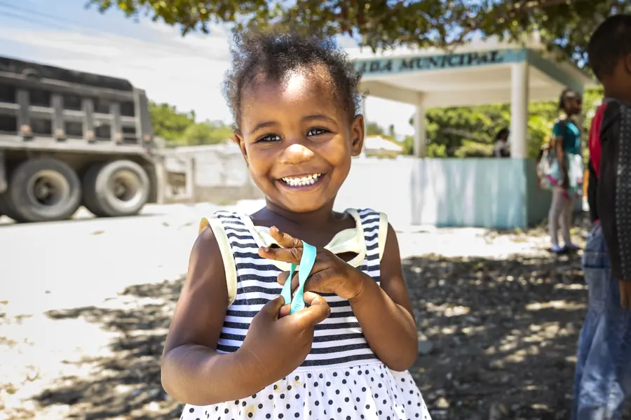 Young girl smiling at an outdoor community event