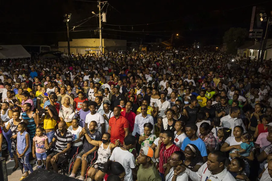Wide view of a large crowd at a night outreach event