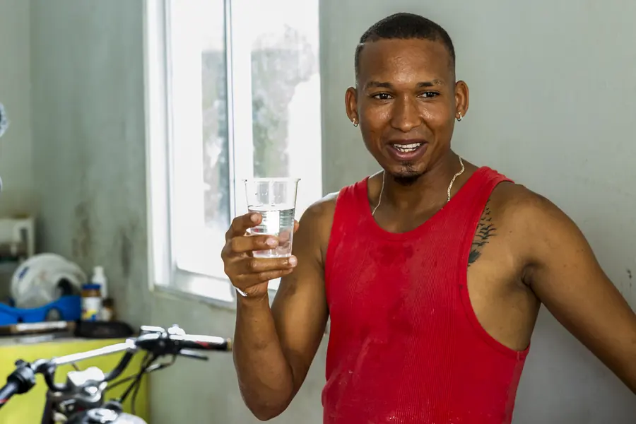 Man raising a glass of filtered water