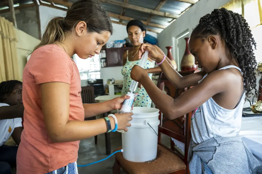 Children assembling a household water filter